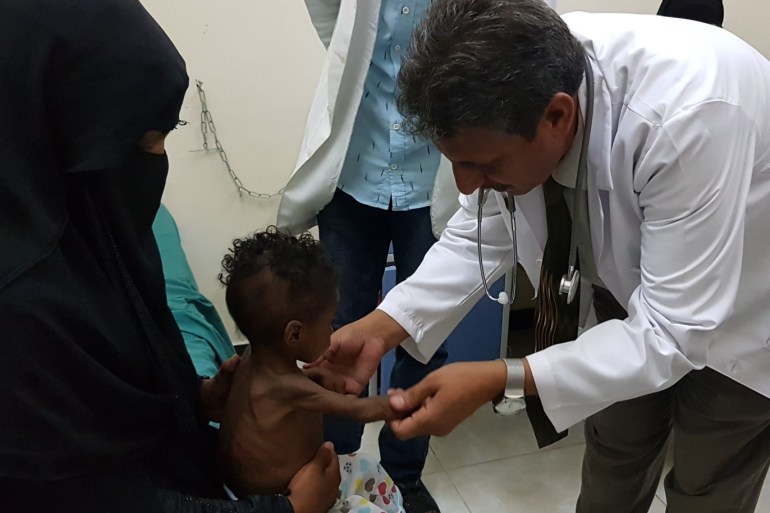 Famine in Yemen- - MARIB, YEMEN - DECEMBER 13 : A doctor checks a child, who is suffering from severe malnutrition, in Marib, Yemen on December 13, 2018. Many children are affected by the famine as a consequence of ongoing war and conflicts in Yemen. Refugees try to make their way to a hospital in Marib in the central Yemen for their children to receive treatment.