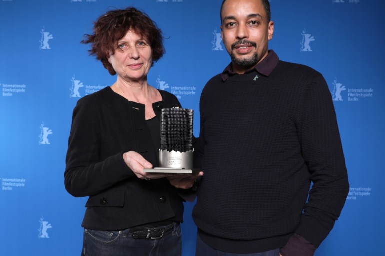 Suhaib Gasmelbari and Marie Balducchi pose with Glashuette Original Dokumentary award for Talking About Trees, after the awards ceremony at the 69th Berlinale International Film Festival in Berlin, Germany, February 16, 2019. Christoph Soeder/Pool via Reuters
