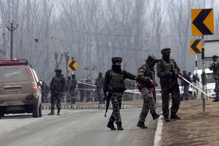 Death toll mounts to 44 after Kashmir car bombing- - KASHMIR,INDIA-FEBRUARY 15 : Indian soldiers stand guard around the wreckage of a bus which was destroyed in Thursday's suicide attack in Lethpora area on the outskirts of Srinagar,Kashmir on February 15, 2019.The death toll in the car bombing has mounted to 44 after the attacker travelling in vehicle had struck Indian paramilitary convoy of more than 50 vehicles on February 14, 2019.