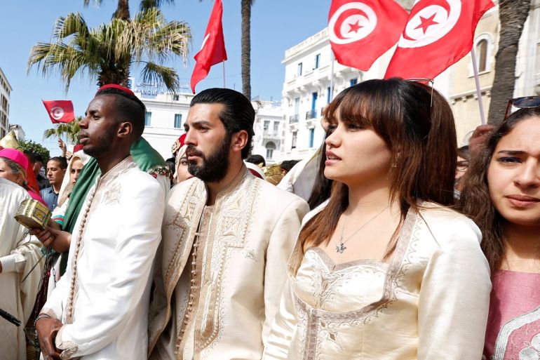 A Tunisian soldier stand in front Tunisians wearing traditional costumes, at Bourguiba Avenue in the capital of Tunis during the National Day of Crafts and Traditional Dress in Tunis, Tunisia March 12, 2017. REUTERS/Zoubeir Souissi