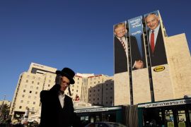 A man walks past a Likud election campaign billboard, depicting U.S. President Donald Trump shaking hands with Israeli Prime Minister Benjamin Netanyahu, in Jerusalem February 4, 2019. REUTERS/Ammar Awad