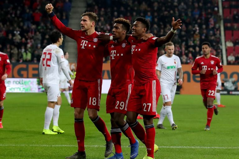 AUGSBURG, GERMANY - FEBRUARY 15: David Alaba #27 of Muenchen celebrate with team mate Kingsley Coman #29 and Leon Goretzka #18 after he scores the 3rd goal during the Bundesliga match between FC Augsburg and FC Bayern Muenchen at WWK-Arena on February 15, 2019 in Augsburg, Germany. (Photo by Alexander Hassenstein/Bongarts/Getty Images)