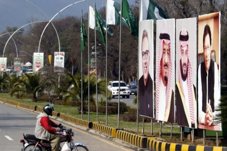 epa07372086 A motercyclist passes by the bilboards showing (L-R) Arif Ali, President of Pakistan, King Salman of Saudi Arab, Mohammad Bin Salman, Crown Prince of Saudi Arab and Imran Khan, Prime Minister of Pakistan as the authorities prepare to welcome Mohammad Bin Salman, the Saudi Crown Prince on the eve of his visit to Islamabad, Pakistan, 15 February 2019. The crown prince of Saudi Arabia will travel this weekend to Pakistan where he is expected to announce multi-b
