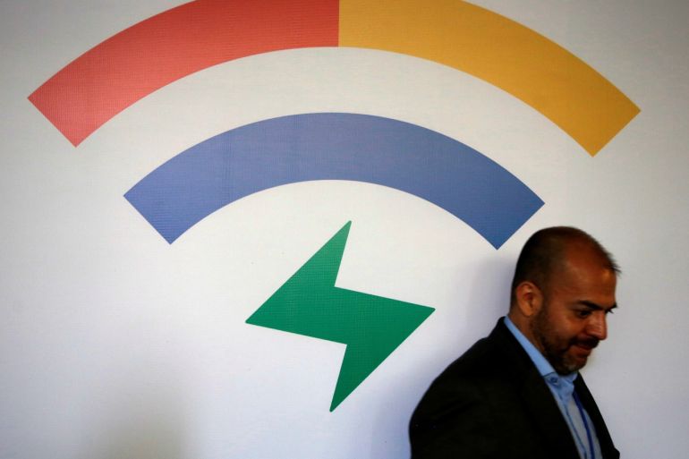 A man walks by the logo of Google Station before a news conference to announce a network of free WI-FI hotspots across the country, in Mexico City, Mexico March 13, 2018. REUTERS/Tomas Bravo