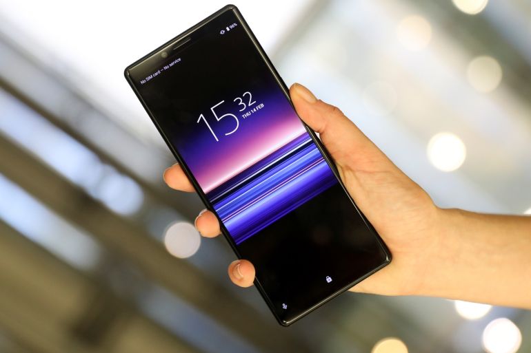 An employee holds a new Sony Xperia X1 in this posed photograph at a pre-launch event at the Sony offices in London, Britain February 14, 2019. Picture taken February 14, 2019. REUTERS/Simon Dawson