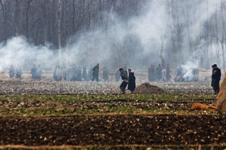 Four Indian soldiers killed in Kashmir gun battle- - KASHMIR, INDIA - FEBRUARY 18: Indian security forces intervene in protesters with tear gas near the encounter site, where nine people including four Indian army men, three militants, a policeman and a civilian were killed in fierce gun-battle between militants, in Pinglena area of Pulwama, Srinagar, Kashmir, India on February 18, 2019. Police claimed that the master mind militant behind the recent Pulwama suicide atta