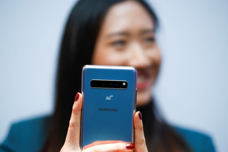 A Samsung employee poses with the new Samsung Galaxy S10 5G smartphone at a press event in London, Britain February 20, 2019. REUTERS/Henry Nicholls