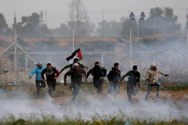 Palestinian demonstrators run away from Israeli fire and tear gas during a protest at the Israel-Gaza border fence, in the southern Gaza Strip February 15, 2019. REUTERS/Ibraheem Abu Mustafa TPX IMAGES OF THE DAY
