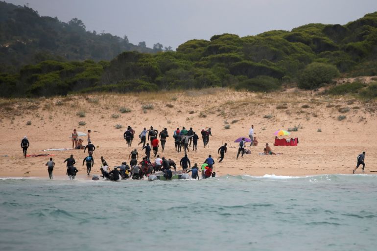 Migrants disembark from a dinghy on Del Canuelo beach after they crossed the Strait of Gibraltar sailing from the coast of Morocco, in Tarifa, southern Spain, July 27, 2018. REUTERS/Jon Nazca SEARCH