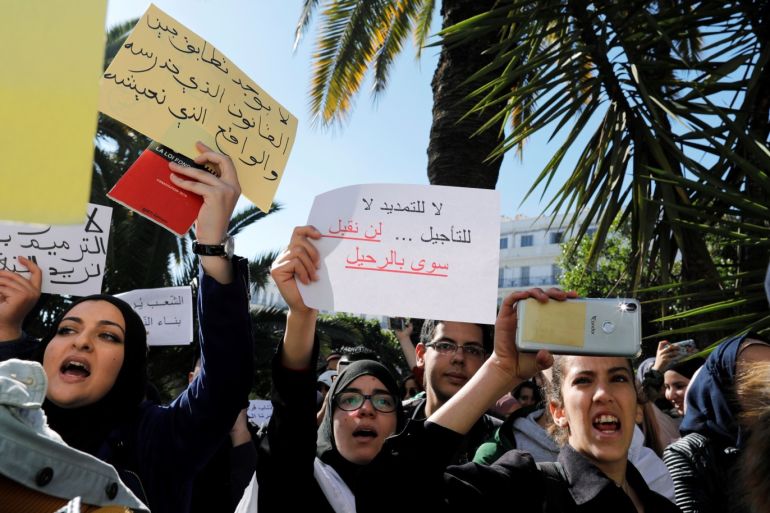 People take part in a protest demanding immediate political change in Algiers, Algeria March 12, 2019. Signs read "There is no correlation between the law we study and the reality we live in" and "No to extension, no to renewal. We will only accept the departure". REUTERS/Zohra Bensemra