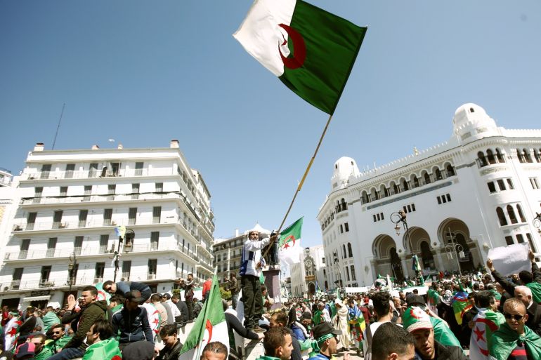 People carry national flags during a protest to demand the removal of President Abdelaziz Bouteflika in Algiers, Algeria March 29, 2019. REUTERS/Ramzi Boudina