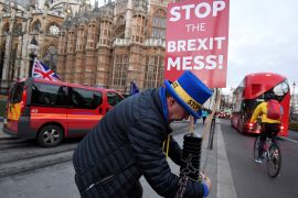 Anti-Brexit protestor Steve Bray secures placards near the Houses of Parliament, in London, Britain, December 10, 2018. Picture taken December 10, 2018. REUTERS/Toby Melville