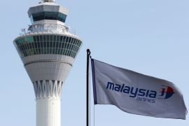 A Malaysian Airlines flag flies in front of the traffic control tower at Kuala Lumpur International Airport in Sepang July 18, 2014. REUTERS/Olivia Harris/File Photo TPX IMAGES OF THE DAY
