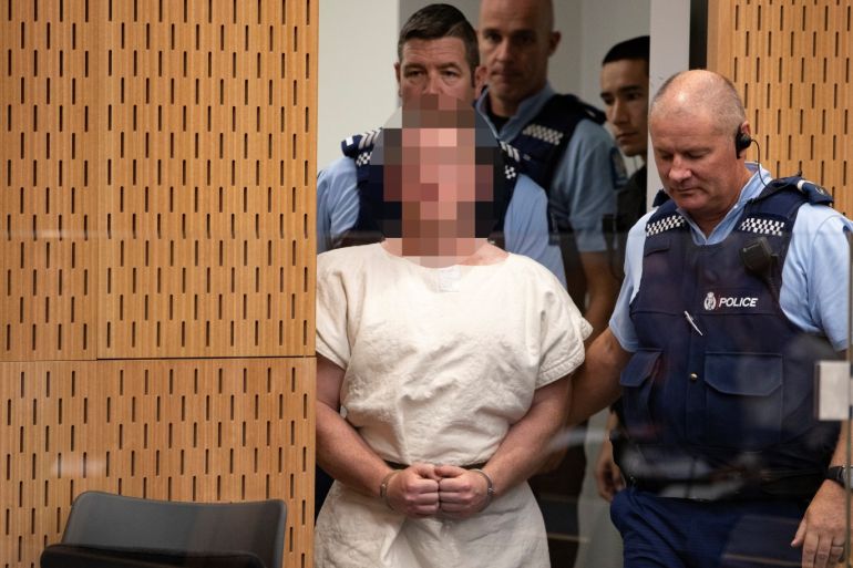 Brenton Tarrant, charged for murder in relation to the mosque attacks, is lead into the dock for his appearance in the Christchurch District Court, New Zealand March 16, 2019. Mark Mitchell/New Zealand Herald/Pool via REUTERS. ATTENTION EDITORS - PICTURE PIXELATED AT SOURCE. SUSPECT FACE MUST BE PIXELATED. ONLY HIS FACE.
