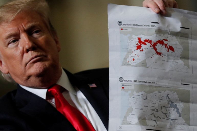 U.S. President Donald Trump shows maps of Syria and Iraq depicting the size of the