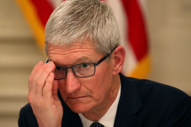 Apple CEO Tim Cook participates in an American Workforce Policy Advisory Board meeting with U.S. President Donald Trump and others in the White House State Dining Room in Washington, U.S., March 6, 2019. REUTERS/Leah Millis