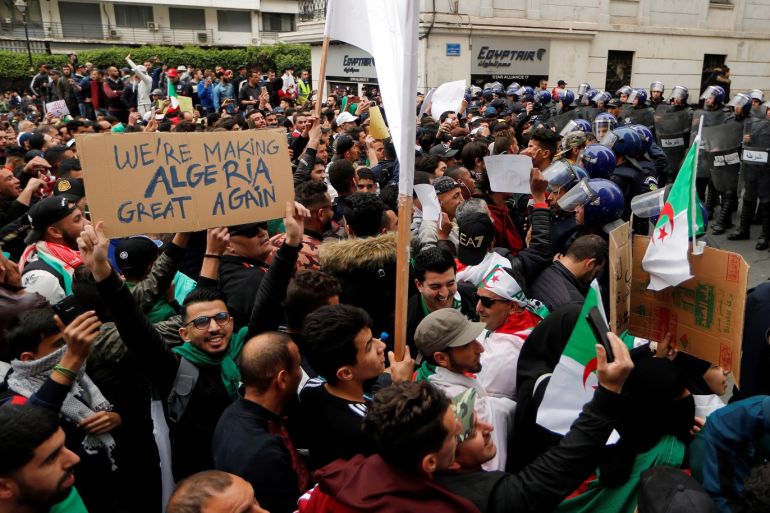 Police members stand guard as people protest against President Abdelaziz Bouteflika, in Algiers, Algeria March 8, 2019. REUTERS/Zohra Bensemra