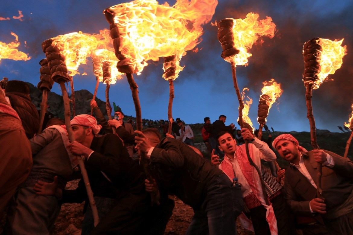 Iraqi Kurdish men carry fire torches, as they celebrate Nowruz Day, a festival marking the first day of spring and the new year, in the town of Akra near Duhok, in Iraqi Kurdistan, Iraq March 20, 2019. REUTERS/Ari Jalal