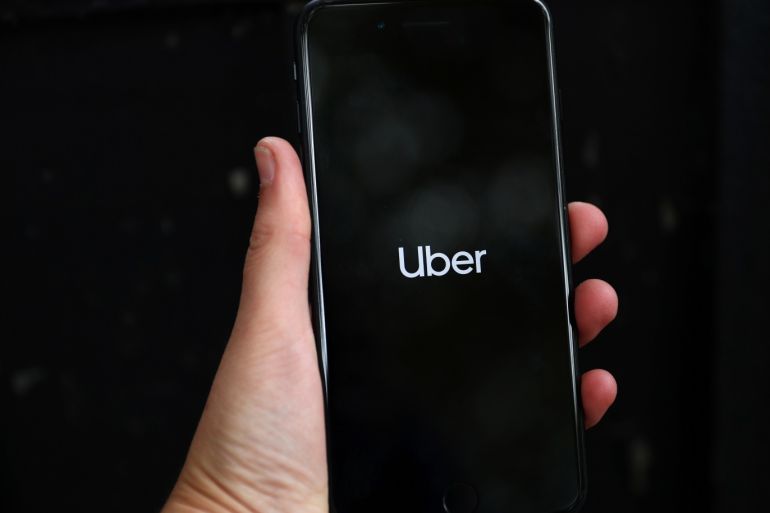 Uber's logo is displayed on a mobile phone in London, Britain, September 14, 2018. REUTERS/Hannah Mckay