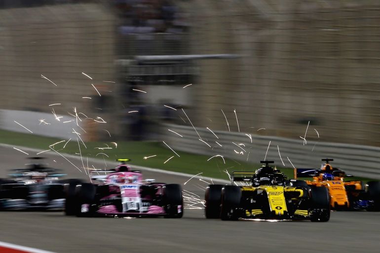 BAHRAIN, BAHRAIN - APRIL 08: Sparks fly behind Esteban Ocon of France and Force India, Nico Hulkenberg of Germany driving the (27) Renault Sport Formula One Team RS18 and Fernando Alonso of Spain driving the (14) McLaren F1 Team MCL33 Renault on track during the Bahrain Formula One Grand Prix at Bahrain International Circuit on April 8, 2018 in Bahrain, Bahrain. (Photo by Charles Coates/Getty Images)