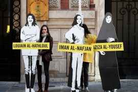 Demonstrators from Amnesty International stage the protest on International Women's day to urge Saudi authorities to release jailed women's rights activists Loujain al-Hathloul, Eman al-Nafjan and Aziza al-Yousef outside the Saudi Arabian Embassy in Paris, France, March 8, 2019. REUTERS/Benoit Tessier