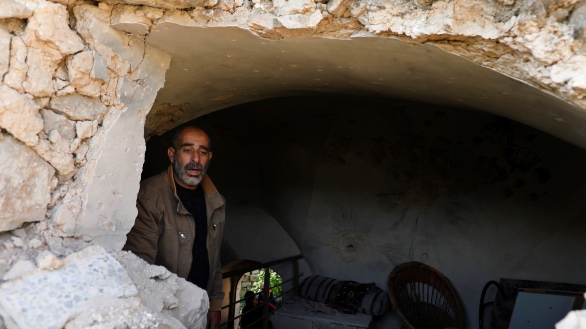 A man inspects a damaged house where a Palestinian gunman was killed by Israeli forces, in Abwein village, in the Israeli-occupied West Bank March 20, 2019. REUTERS/Mohamad Torokman