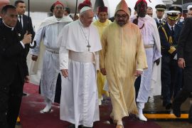 Pope Francis is received by Morocco's King Mohammed VI upon disembarking from his plane at Rabat-Sale International Airport near the capital Rabat, Morocco, March 30, 2019. Fadel Senna/Pool via REUTERS