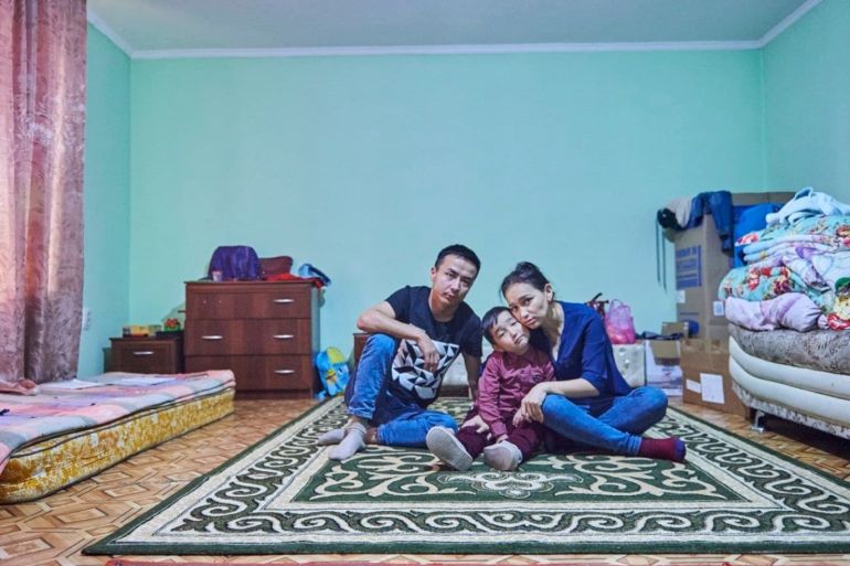 Zharqynbek Otan with his wife, Shynar Kylysheva, and their 6-year-old son at home in Almaty, Kazakhstan, on Feb. 26. (Izturgan Aldauyev/For The Washington Post)