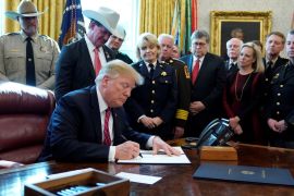 President Donald Trump signs his veto of the congressional resolution to end his emergency declaration to get funds for a border wall during a ceremony in the Oval Office of the White House in Washington, U.S., March 15, 2019. REUTERS/Jonathan Ernst