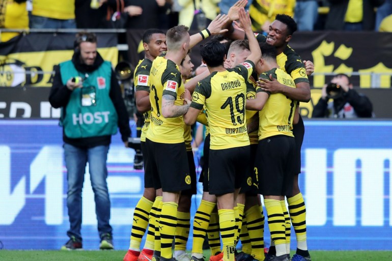 DORTMUND, GERMANY - MARCH 30: Paco Alcacer of Borussia Dortmund celebrates with teammates after scoring his team's first goal during the Bundesliga match between Borussia Dortmund and VfL Wolfsburg at Signal Iduna Park on March 30, 2019 in Dortmund, Germany. (Photo by Christof Koepsel/Bongarts/Getty Images)
