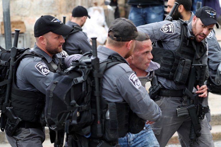 Israeli policemen detain a Palestinian protestor during scuffles outside the compound housing al-Aqsa Mosque in Jerusalem's Old City March 12, 2019 REUTERS/Ammar Awad