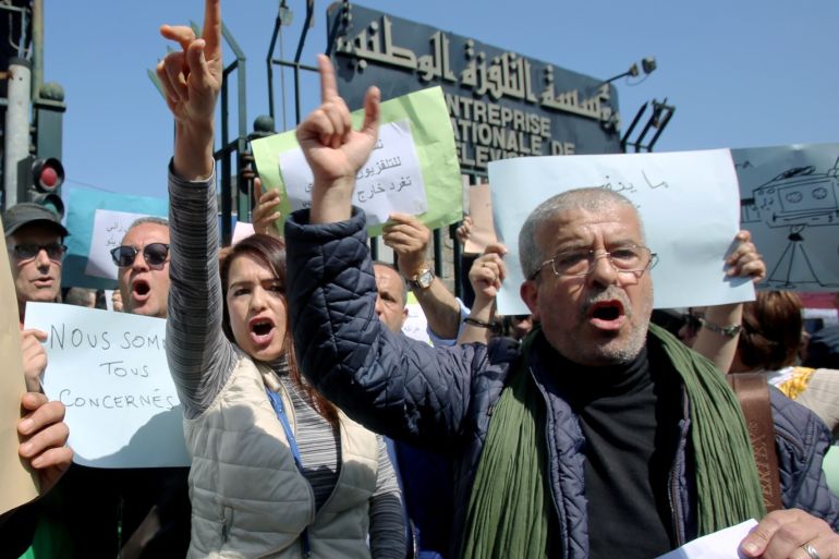 Journalists working at state media carry banners and shout slogans during a protest in front of the state TV building to demand freedom to cover mass protests against President Abdelaziz Bouteflika, in Algiers, Algeria March 25, 2019. REUTERS/Ramzi Boudina