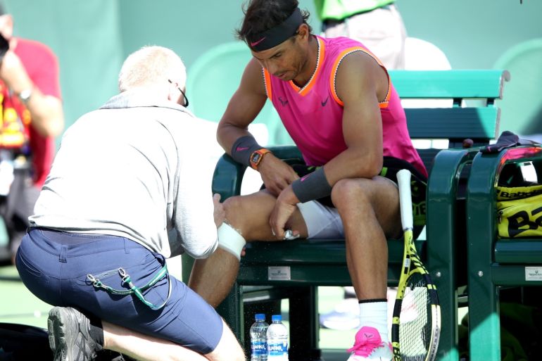 INDIAN WELLS, CALIFORNIA - MARCH 15: Rafael Nadal of Spain is tended to by a trainer during a crossover against Karen Khachanov of Russia during their men's singles quarter final match at the BNP Paribas Open at the Indian Wells Tennis Garden on March 15, 2019 in Indian Wells, California. Sean M. Haffey/Getty Images/AFP== FOR NEWSPAPERS, INTERNET, TELCOS & TELEVISION USE ONLY ==