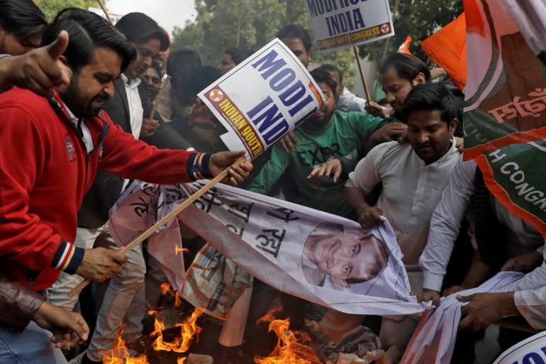 Activists of the youth wing of India's main opposition Congress party burn banners with an image of billionaire jeweller Nirav Modi during a protest in New Delhi, India February 16, 2018. REUTERS/Saumya Khandelwal