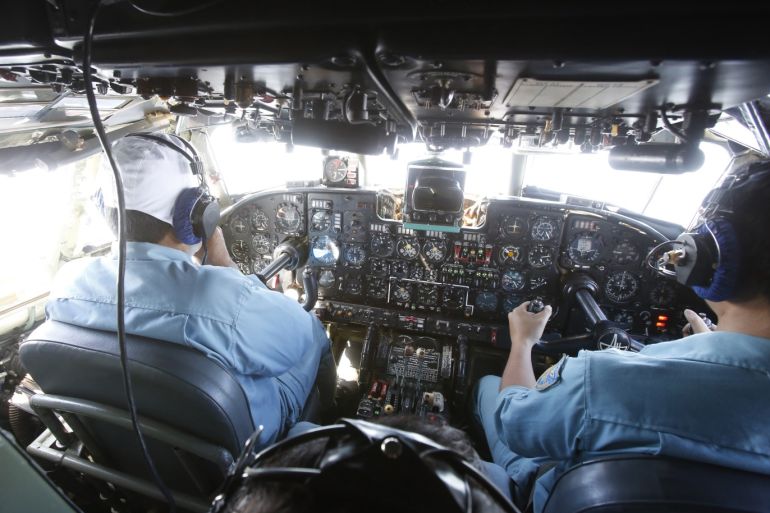 Military officers work within the cockpit of an aircraft AN-26 belonging to the Vietnam Air Force during a search and rescue mission off Vietnam's Tho Chu island March 10, 2014. The disappearance of Malaysia Airlines flight MH370 is an