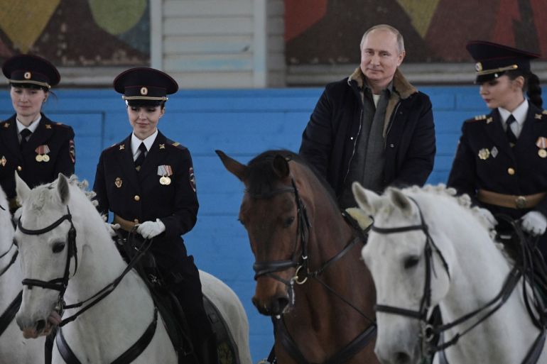Russian President Vladimir Putin (2nd R) rides a horse as he attends a meeting with female officers of a mounted police unit to congratulate them on the upcoming International Women's Day in Moscow, Russia March 7, 2019. Sputnik/Alexei Nikolsky/Kremlin via REUTERS ATTENTION EDITORS - THIS IMAGE WAS PROVIDED BY A THIRD PARTY.
