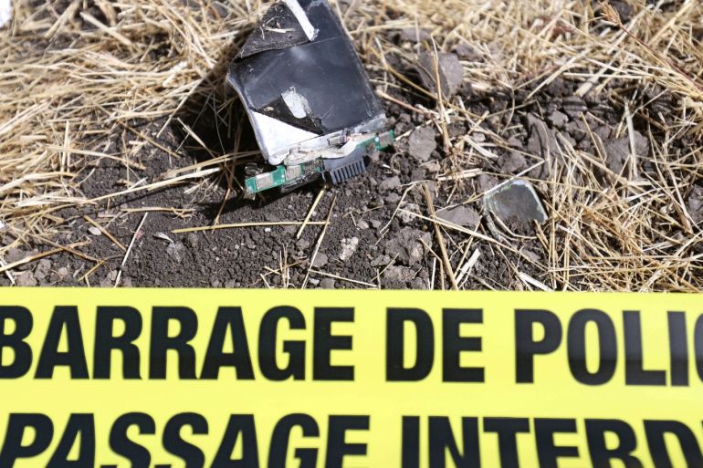 A component from a computer is seen behind a police cordon at the scene of the Ethiopian Airlines Flight ET 302 plane crash, near the town of Bishoftu, southeast of Addis Ababa, Ethiopia March 11, 2019. REUTERS/Tiksa Negeri