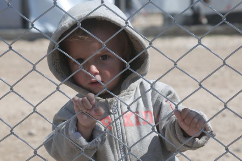 A child looks through a chain linked fence at al-Hol displacement camp in Hasaka governorate, Syria March 8, 2019. REUTERS/Issam Abdallah