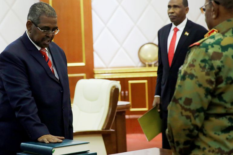 Mohamed Tahir Ayala is sworn in as prime minister in front of Sudan's President Omar al-Bashir during a swearing in ceremony of new officials after Bashir dissolved the central and state governments in Khartoum, Sudan February 24, 2019. REUTERS/Mohamed Nureldin Abdallah