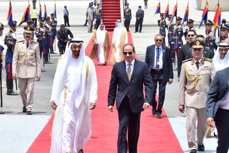 Egyptian President Abdel Fattah al-Sisi walks with Abu Dhabi's Crown Prince Sheikh Mohammed bin Zayed al-Nahyan on his arrival at Cairo's Airport, Egypt, August 7, 2018 in this handout picture courtesy of the Egyptian Presidency. The Egyptian Presidency/Handout via REUTERS ATTENTION EDITORS - THIS IMAGE WAS PROVIDED BY A THIRD PARTY