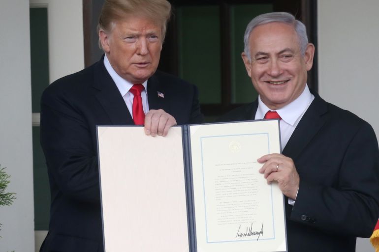 U.S. President Donald Trump and Israel's Prime Minister Benjamin Netanyahu hold up a proclamation recognizing Israel's sovereignty over the Golan Heights as Netanyahu exits the White House from the West Wing in Washington, U.S. March 25, 2019. REUTERS/Leah Millis