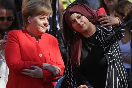 BERLIN, GERMANY - MAY 07: German Chancellor Angela Merkel poses for a selfie with a Muslim pupil during a visit to the Jane-Addams-Schule secondary school on May 7, 2018 in Berlin, Germany. Merkel was visiting the school to learn about European Union prjects the school is involved in and to discuss the role of the E.U. with pupils. (Photo by Sean Gallup/Getty Images)