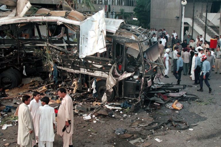 A bus sits in ruins after an explosion in Karachi on May 8, 2002. [According to police nine French nationals were among the 11 dead in the explosion which also wounded at least 22 people after a bomb exploded near a hotel and near the bus on Wednesday.]