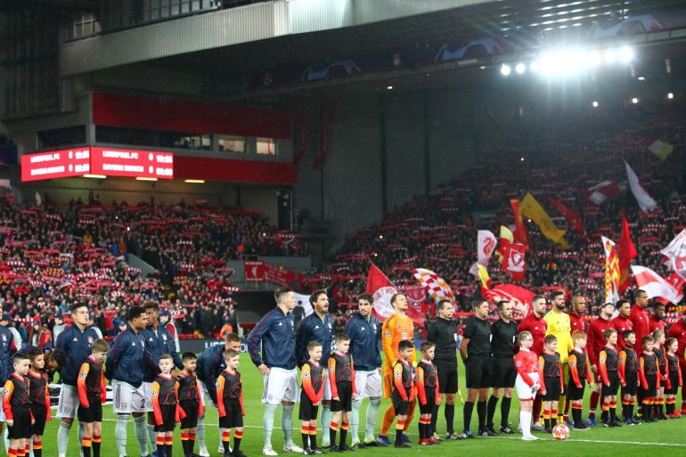 LIVERPOOL, ENGLAND - FEBRUARY 19: Players,officials and mascots line up prior to the UEFA Champions League Round of 16 First Leg match between Liverpool and FC Bayern Muenchen at Anfield on February 19, 2019 in Liverpool, England. (Photo by Clive Brunskill/Getty Images)