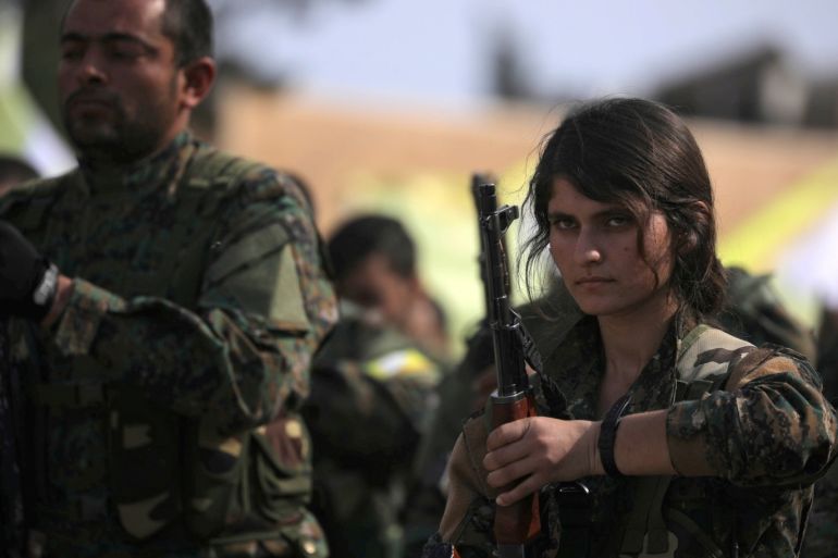 A fighter of Syrian Democratic Forces (SDF) holds her weapon as they announce the destruction of Islamic State's control of land in eastern Syria, at al-Omar oil field in Deir Al Zor, Syria March 23, 2019. REUTERS/Rodi Said TPX IMAGES OF THE DAY