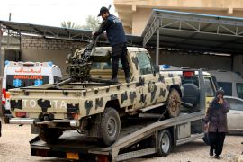A police officer from the internationally recognised government checks a military vehicle, which was confiscated from Libyan commander Khalifa Haftar's troops, in Zawiyah, west of Tripoli, Libya April 5, 2019. REUTERS/Hani Amara