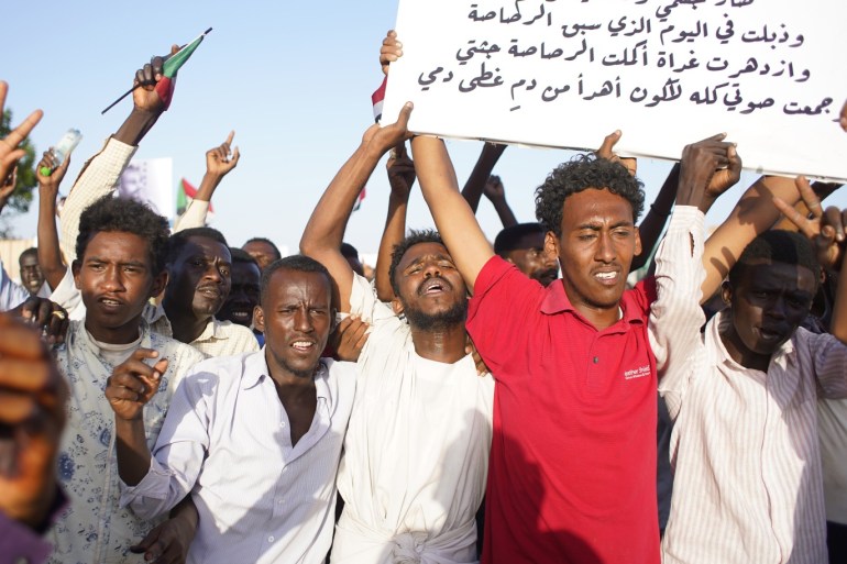 epa07504806 People chant slogans during a protest outside of the Military headquarters in Khartoum, Sudan, 13 April 2019. According to reports, thousands of Sudanese people demonstrated in front of the Military headquarters in Khartoum demanding that former President Omar al-Bashir face trial, as well as the military-led transitional council. Sudanese defense minister and head of Sudan's military council, Awad Ibn Auf, stepped down a day after leading a military coup t