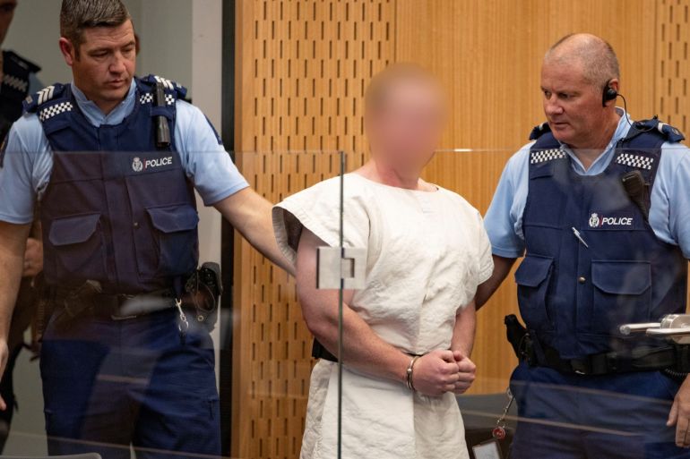 Brenton Tarrant, charged for murder in relation to the mosque attacks, is lead into the dock for his appearance in the Christchurch District Court, New Zealand March 16, 2019. Mark Mitchell/New Zealand Herald/Pool via REUTERS. ATTENTION EDITORS - PICTURE PIXELATED AT SOURCE. SUSPECT FACE MUST BE PIXELATED. ONLY HIS FACE.