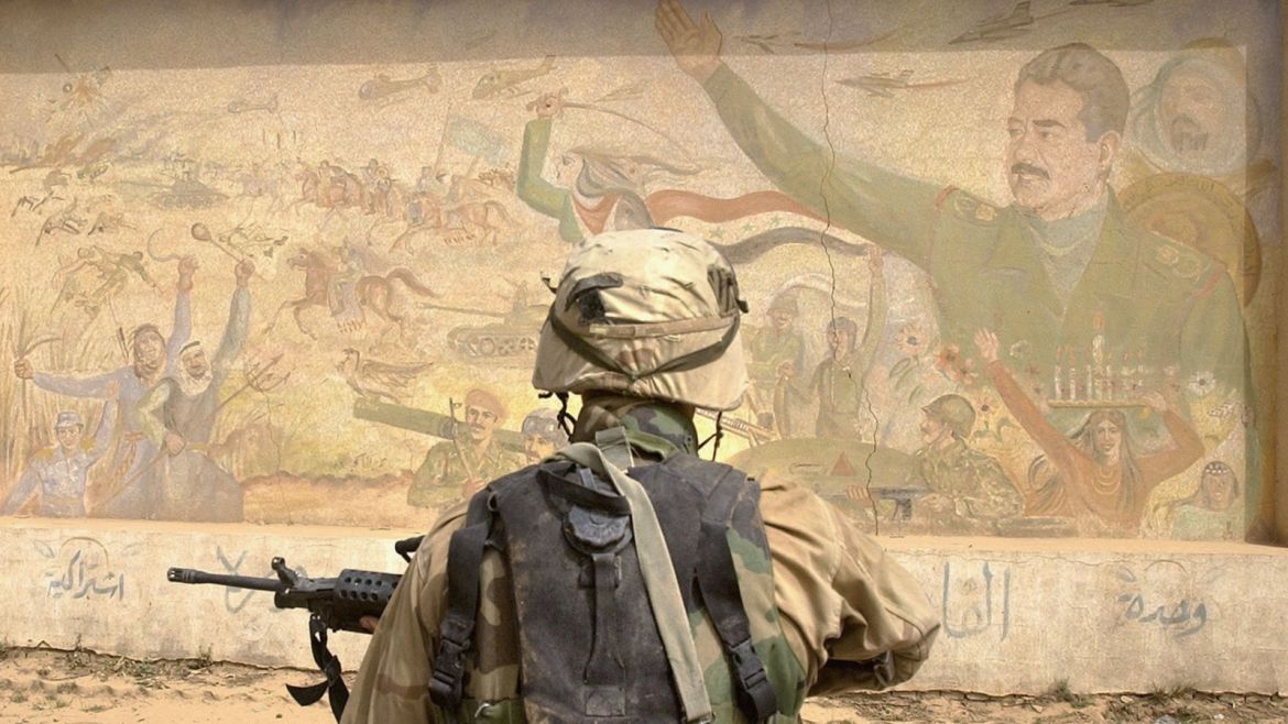 BAGHDAD, IRAQ - APRIL 8: U.S. Army 3rd Division 3-7 infantry soldiers examine a Saddam Hussein mural as they conduct a neighborhood patrol on the outside perimeter of the Baghdad International Airport April 8, 2003. U.S. Forces remain in complete control of the airport and have begun to land military planes there as well as conducting missions into the city center. (Photo by Scott Nelson/Getty Images)