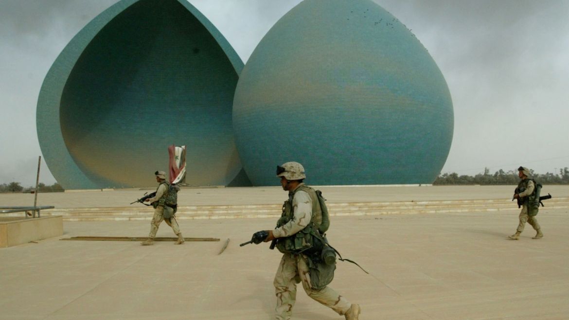 U.S. Marines from Lima Company, a part of a 7-th Marine Regiment, walkin front of the Martyrs Monument, during the operation of securing thecentre of Baghdad on April 9, 2003. Iraqis joyously welcomed U.S.Marines driving through eastern Baghdad on Wednesday and looters movedin as the remnants of Saddam Hussein's rule collapsed. Hundreds ofjubilant Iraqis cheered, danced, waved and threw flowers as Marinesadvanced through eastern Baghdad and into the centre of Saddam's seatof power. REUTERS/Oleg PopovOP/AA